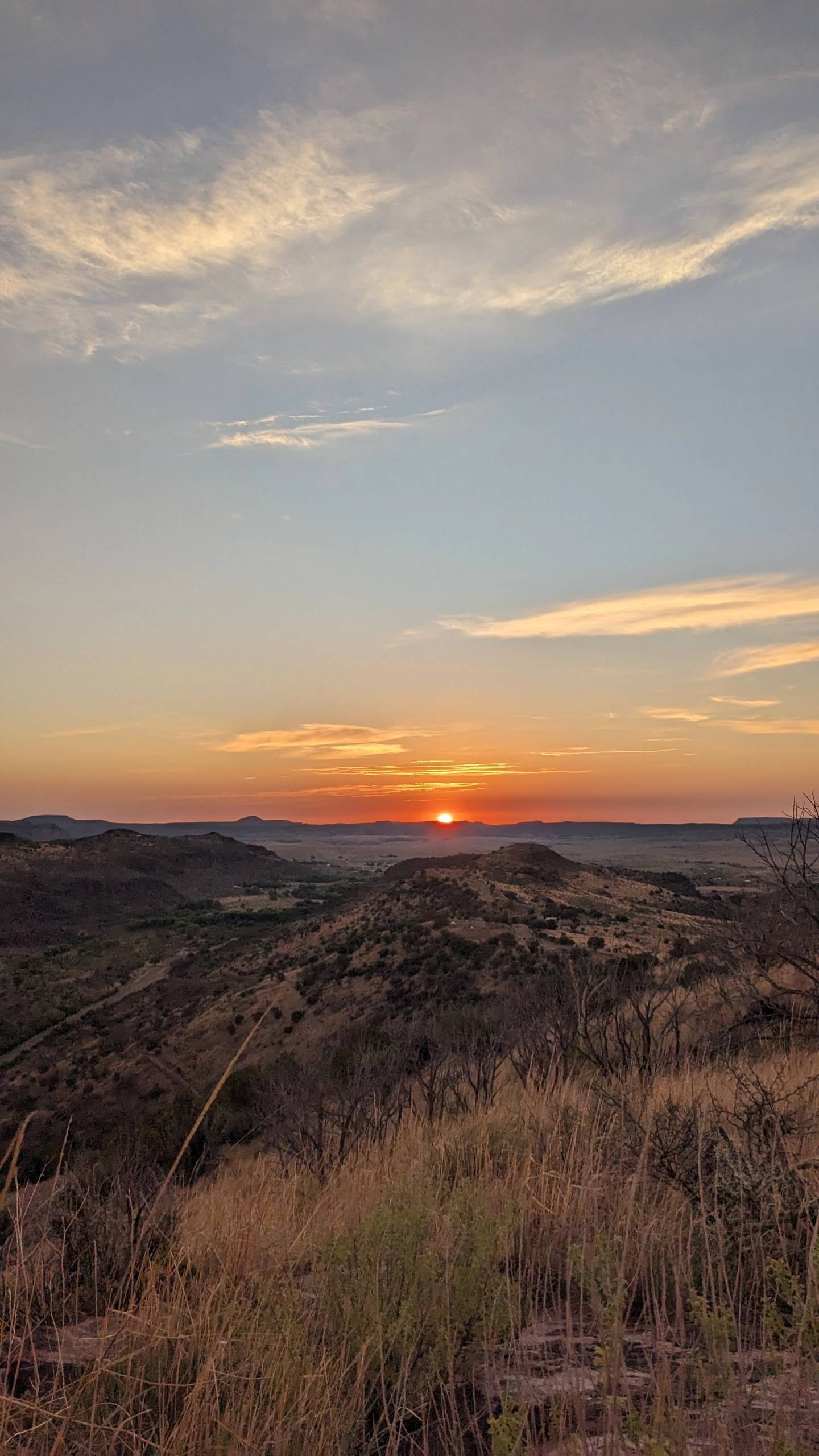 The sun going down over the Davis Mountains, the dark-sky country tent campers sleep under