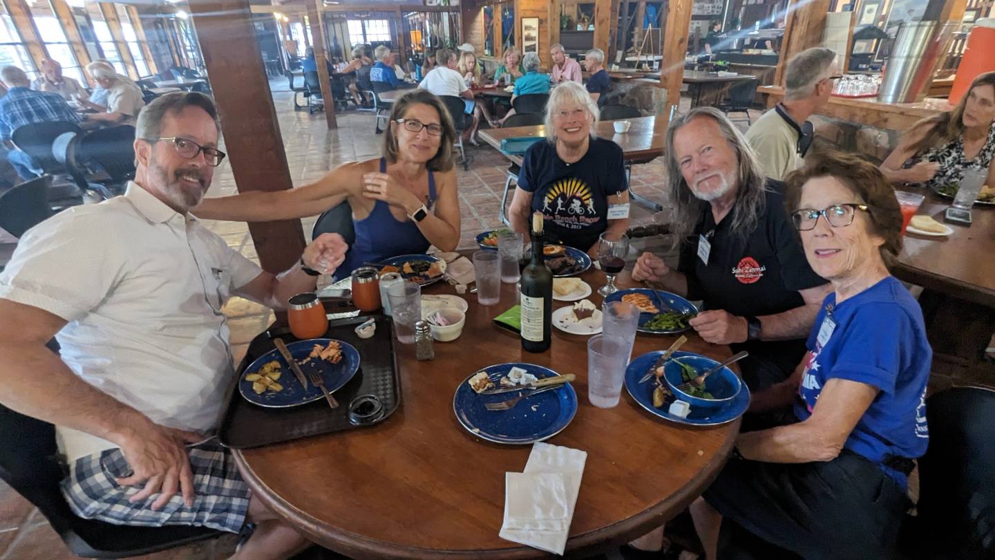 Campers sharing dinner around a table in the ranch dining hall
